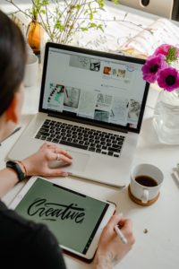 woman at her computer, she is excited to start her small business 